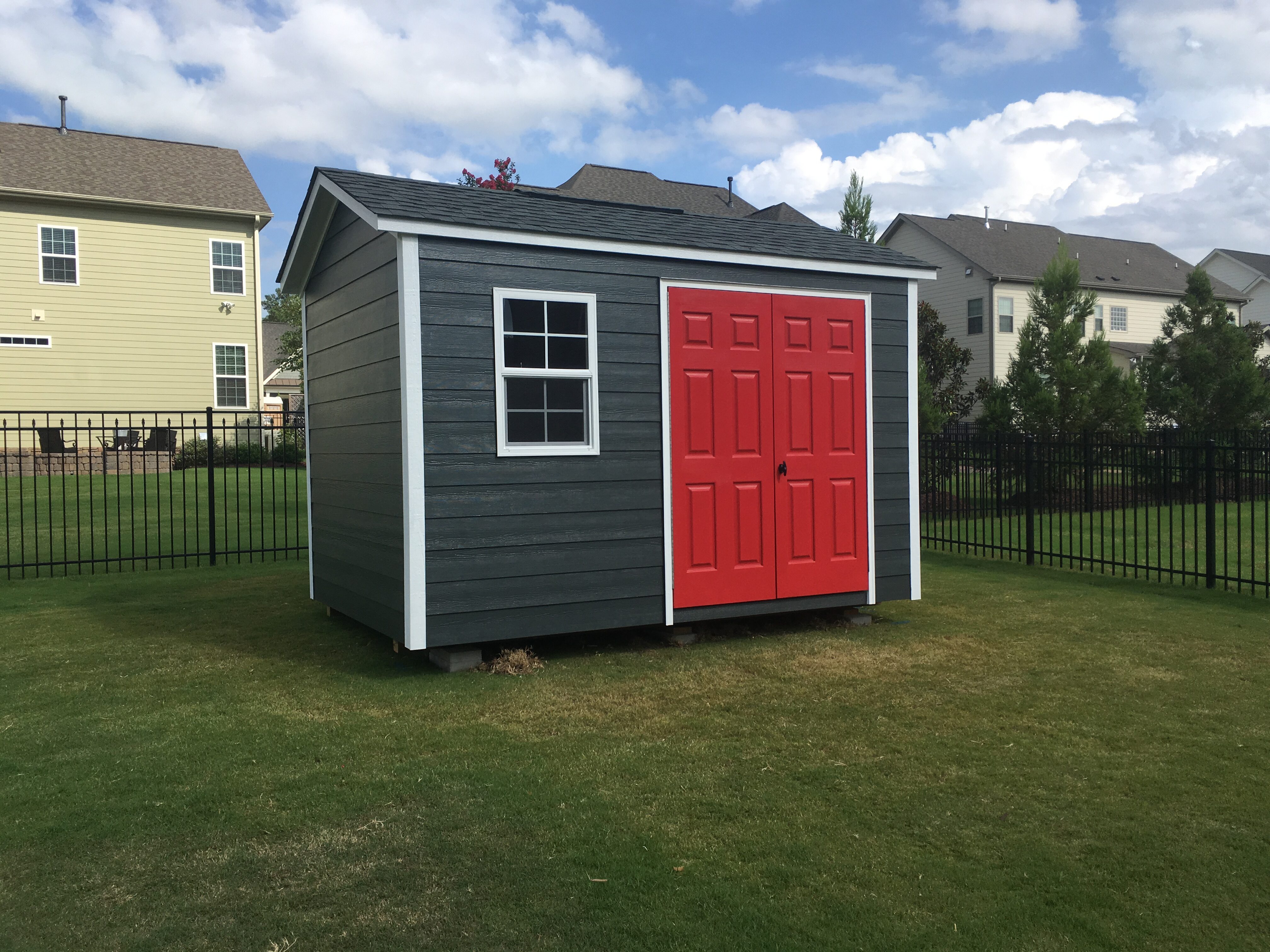 gray statesman with white trim and red door