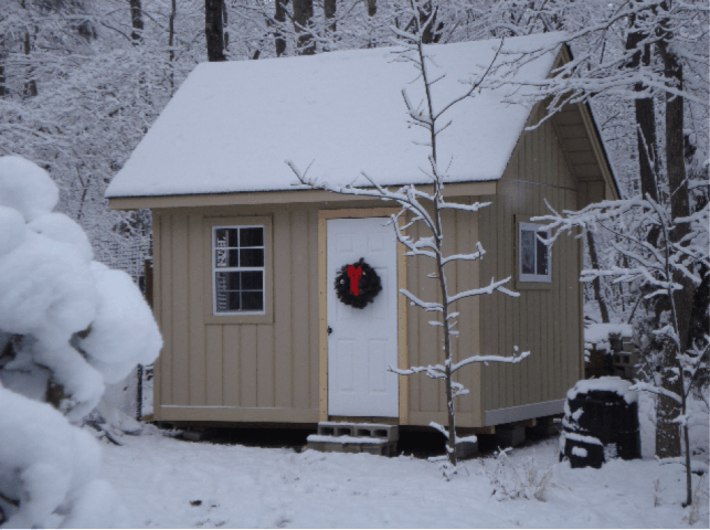 tan Heritage 8/12 Roof Pitch in the snow with wreath on the white door