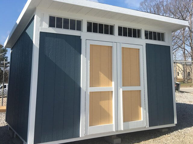 Upgrade Studio shed, navy with white trim