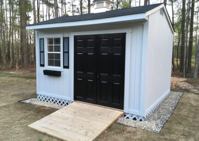 Custom built tackroom storage barn with black gable doors
